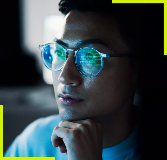 man with computer reflection on glasses