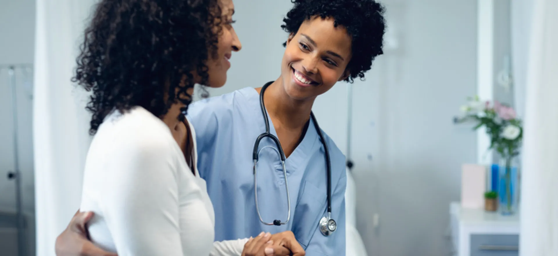 medical professional smiling with female patient