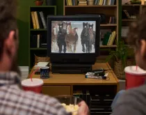 people watching commercial of horses on old tv
