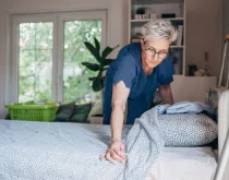 nurse making hospital bed at home