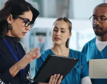 nurses talking to woman in business attire