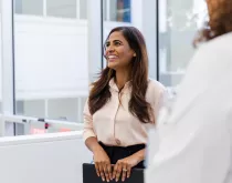 executive admin smiling with coworkers