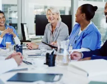 hospital staff sitting at a meeting at a table