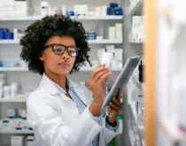 Pharmacist reviewing prescriptions in a pharmacy setting
