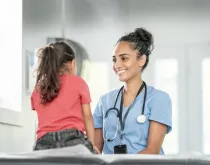 friendly nurse smiling at little girl