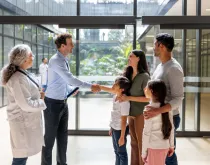 Family at the hospital greeting professionals with a handshake