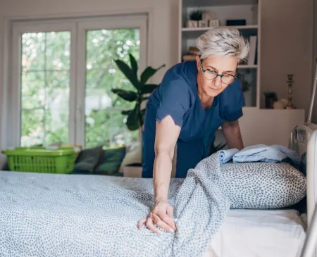 nurse making hospital bed at home