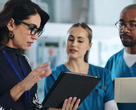 nurses talking to woman in business attire
