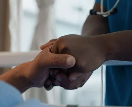 medical professional holding hand of patient