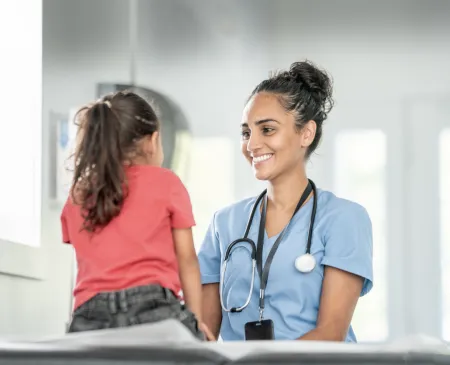 friendly nurse smiling at little girl