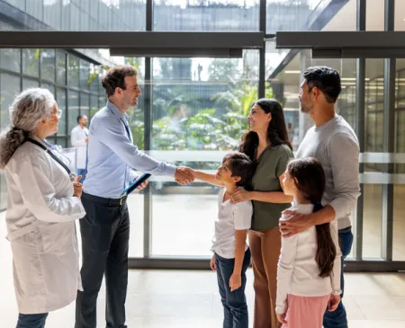 Family at the hospital greeting professionals with a handshake