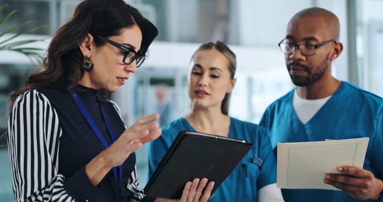 nurses talking to woman in business attire