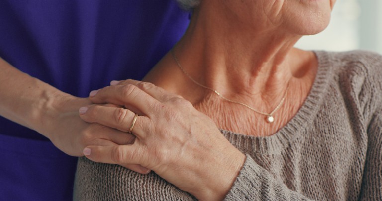 new standards for high-value cancer care, nurse hand comforting patient