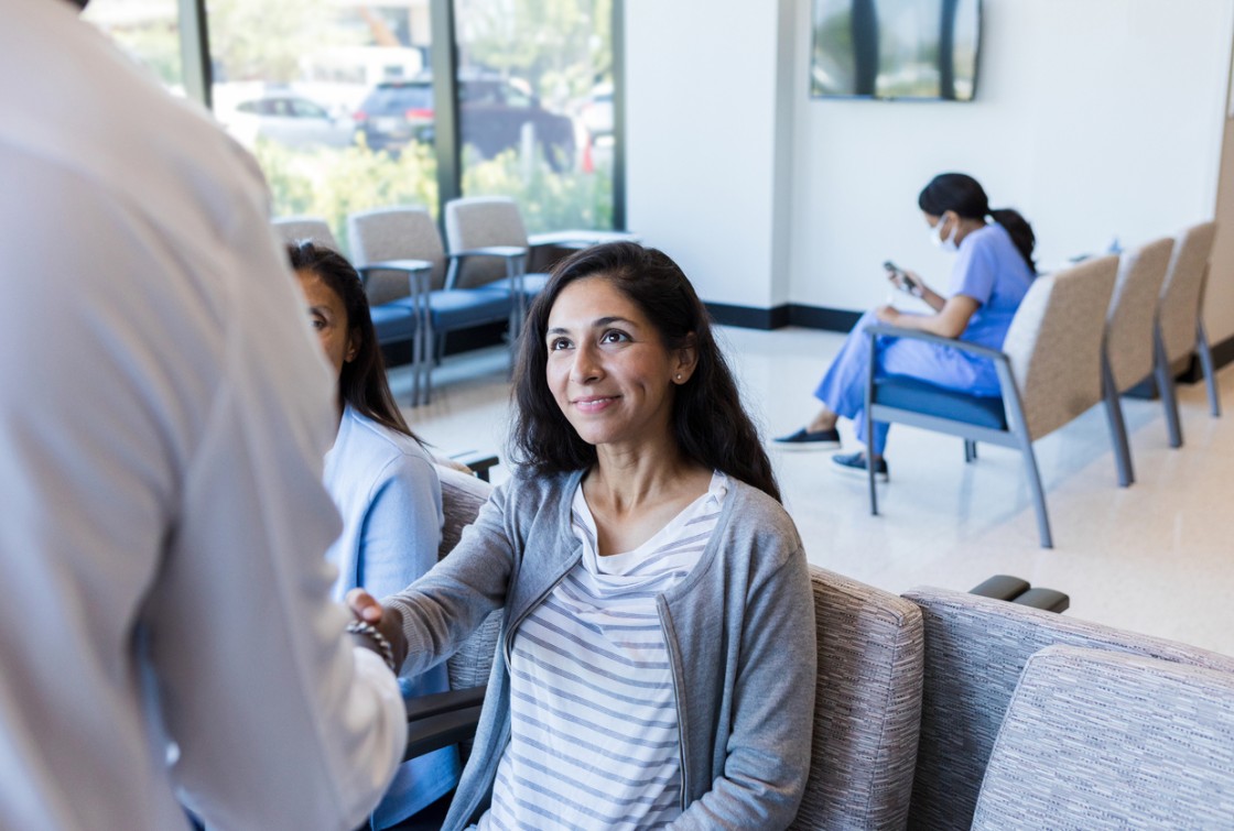 patient in waiting room meeting doctor