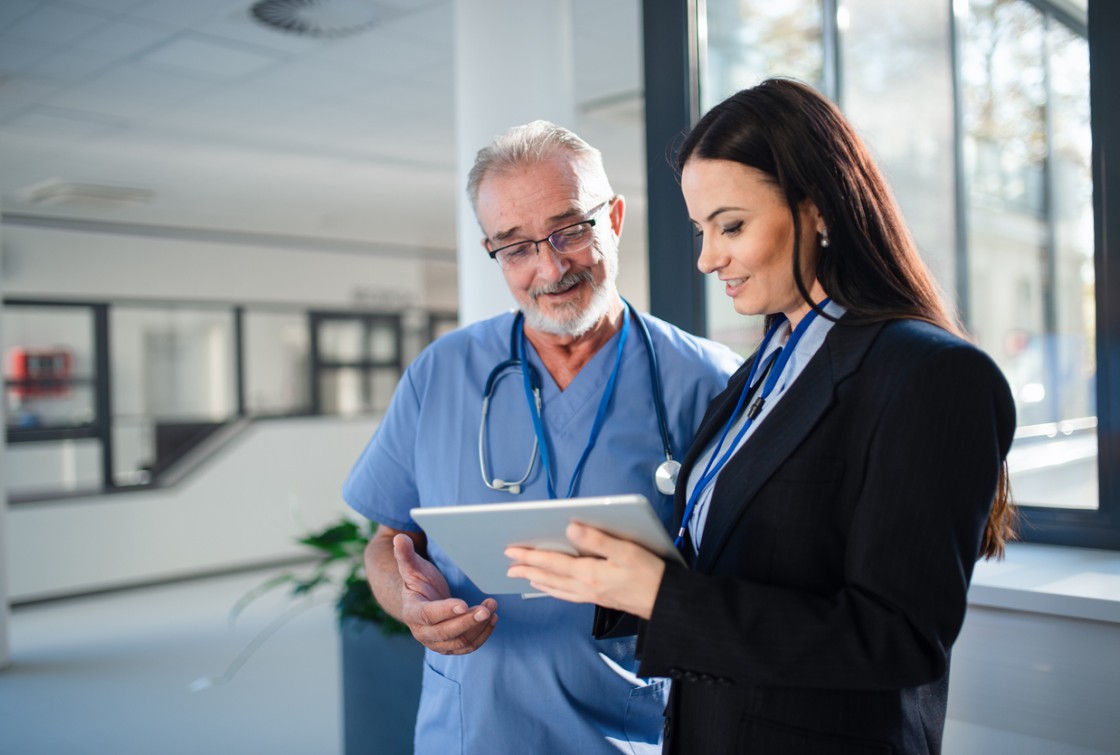 doctor talking and looking at tablet