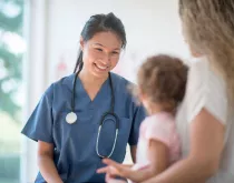 doctor or nurse talking with child and mom