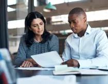 businessman and businesswoman going over paperwork