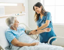 Nurse taking elderly woman blood pressure