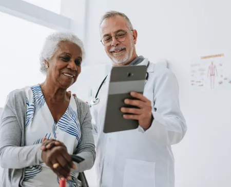 doctor and patient looking at tablet