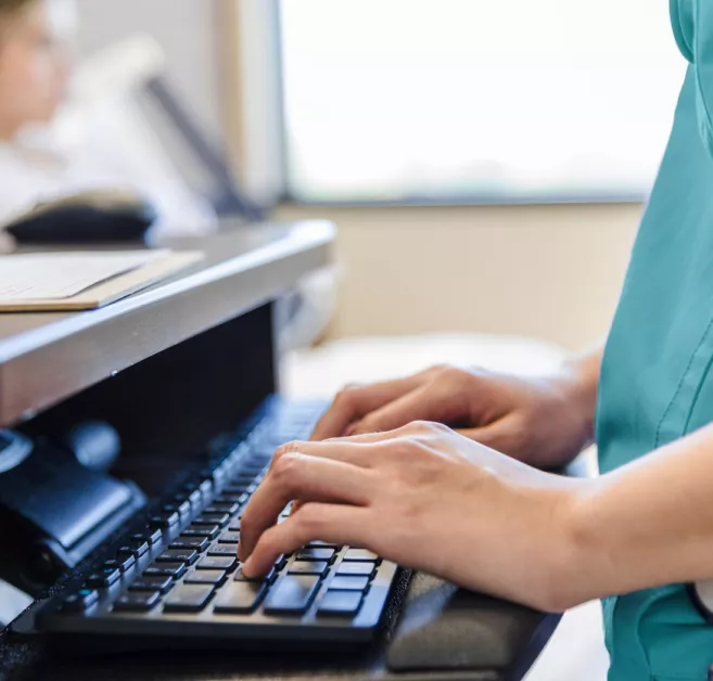 doctor or nurse typing on keyboard